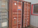 two shipping containers sitting next to each other outside a building