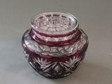 a small glass jar with a lid sitting on a table