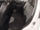 the interior of a white car with black seats and a red seat belt