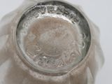 a close up of a silver vase with a white background