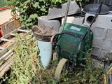 a pile of junk in the yard next to a building