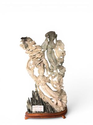 statue of a woman holding a bird on a wooden base