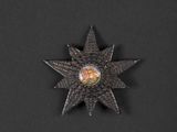 an image of a metal star on a black surface