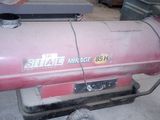 an image of a gas heater sitting in a garage