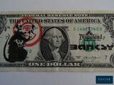 une image d'un billet d'un dollar sur lequel figure un rat
