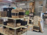 several shelves with baskets and boxes on them in a warehouse