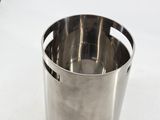 a metal cup that is sitting on a table