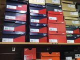 boxes of various sizes and colors are stacked on a shelf