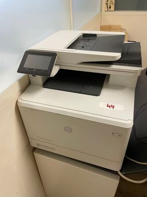 a printer that is sitting on top of a cabinet