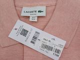 a close up of a pink shirt with a tag on it