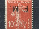 an old stamp with a woman on it on a black surface