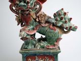 statue of a dragon on a pedestal on a white background
