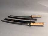 three different types of knives on a white surface