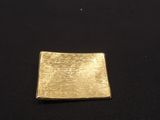 a close up of a gold plate on a black surface