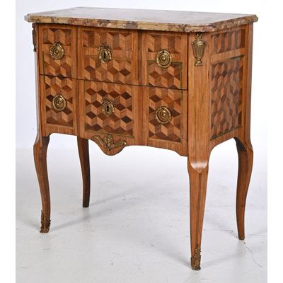 a wooden chest of drawers with a marble top