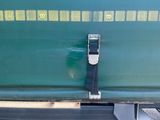 a close up of a green train car with a black seat belt