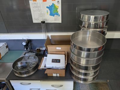 many pots and pans sitting on a table in a kitchen