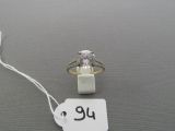 a ring with a diamond on it on a string
