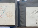 two old envelopes with stamps are sitting on top of a table