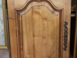 a wooden cabinet with a door that has a handle on it
