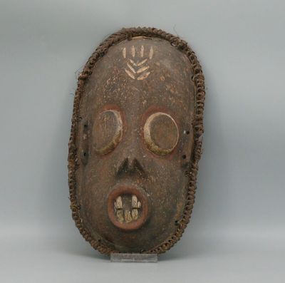 a wooden mask that has a face on it