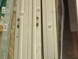 several pieces of wood are stacked on top of each other in a warehouse