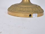 an image of a gold candle holder on a white surface