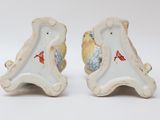 two figurines of birds sitting on top of each other