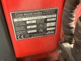 a close up of a red vehicle with a black and white sticker on it