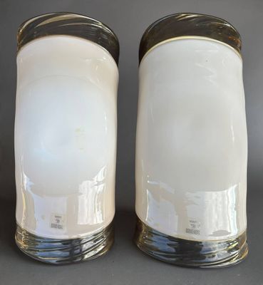 pair of white salt and pepper shakers with gold rims