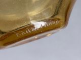 a close up of a glass vase with a label on it
