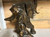 a statue of an elephant and a dog on a shelf
