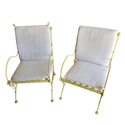 pair of white and gold metal patio chairs with white cushions
