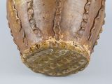 a close up of a vase on a white surface