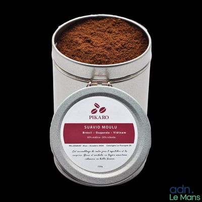 coffee powder in a tin with a lid on a black background