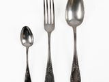 three spoons, a fork, and a spoon on a white surface