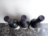 three bottles of wine that are sitting on a table