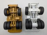 two toy trucks that are sitting side by side on a table
