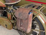 an old motorcycle with a saddle on the back of it