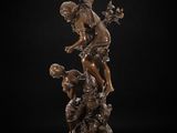 a bronze statue of a boy and a girl on a pedestal