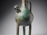 an image of a green vase with a bird on it