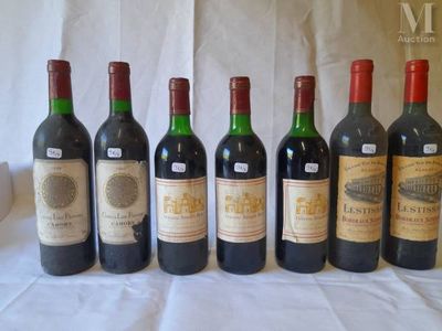 several bottles of wine are lined up on a table