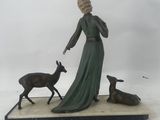 statue of a woman with a deer and a dog on a marble base