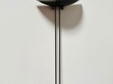an image of a black floor lamp on a white wall