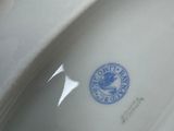 a white porcelain bowl with a blue seal on it