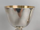 a silver cup with blue and gold decorations on it