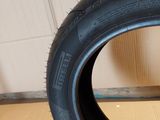 a close up of a tire on a wooden floor with a wall in the background