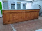 a wooden counter with a metal top in a tent