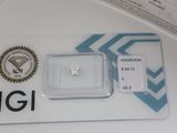 a small diamond on a card on a table