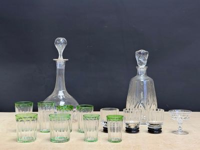 a lot of glasses and a decanter on a table